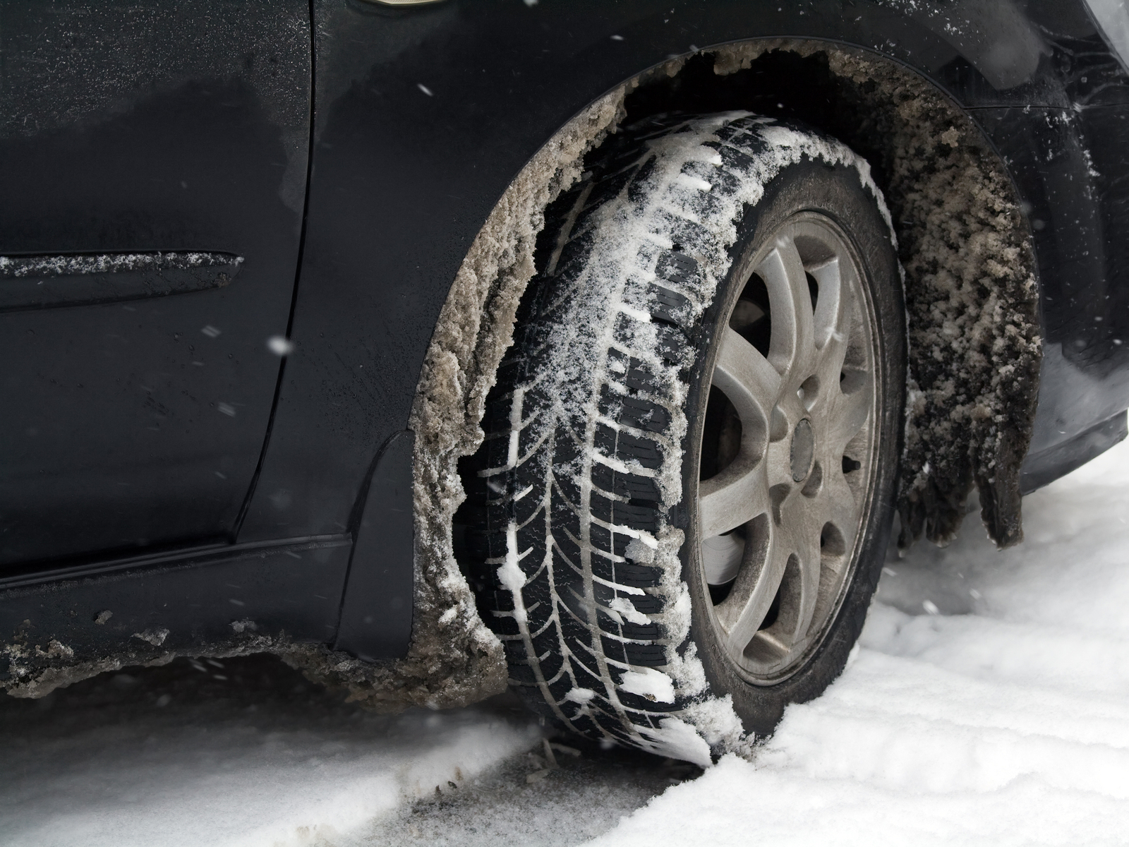 bigstock-dirty-car-tire-with-snow-25273616
