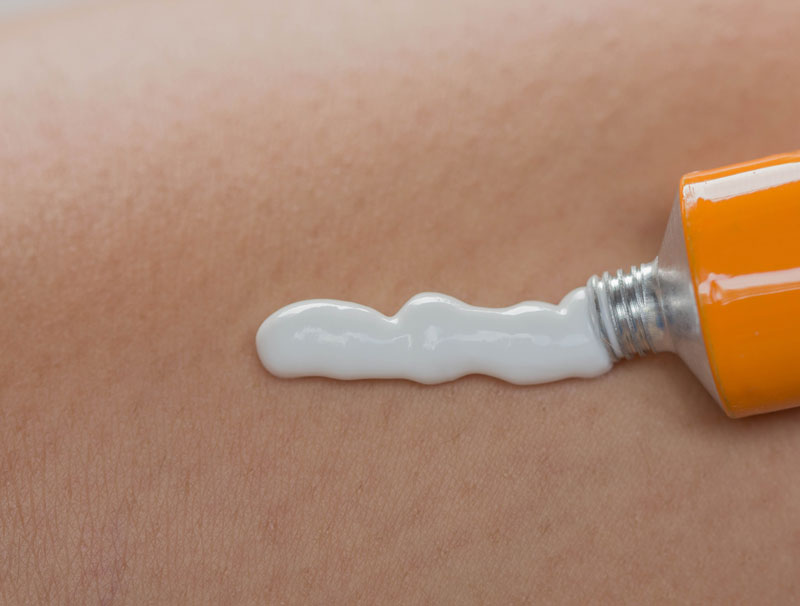 Woman looking at plate with single carrot