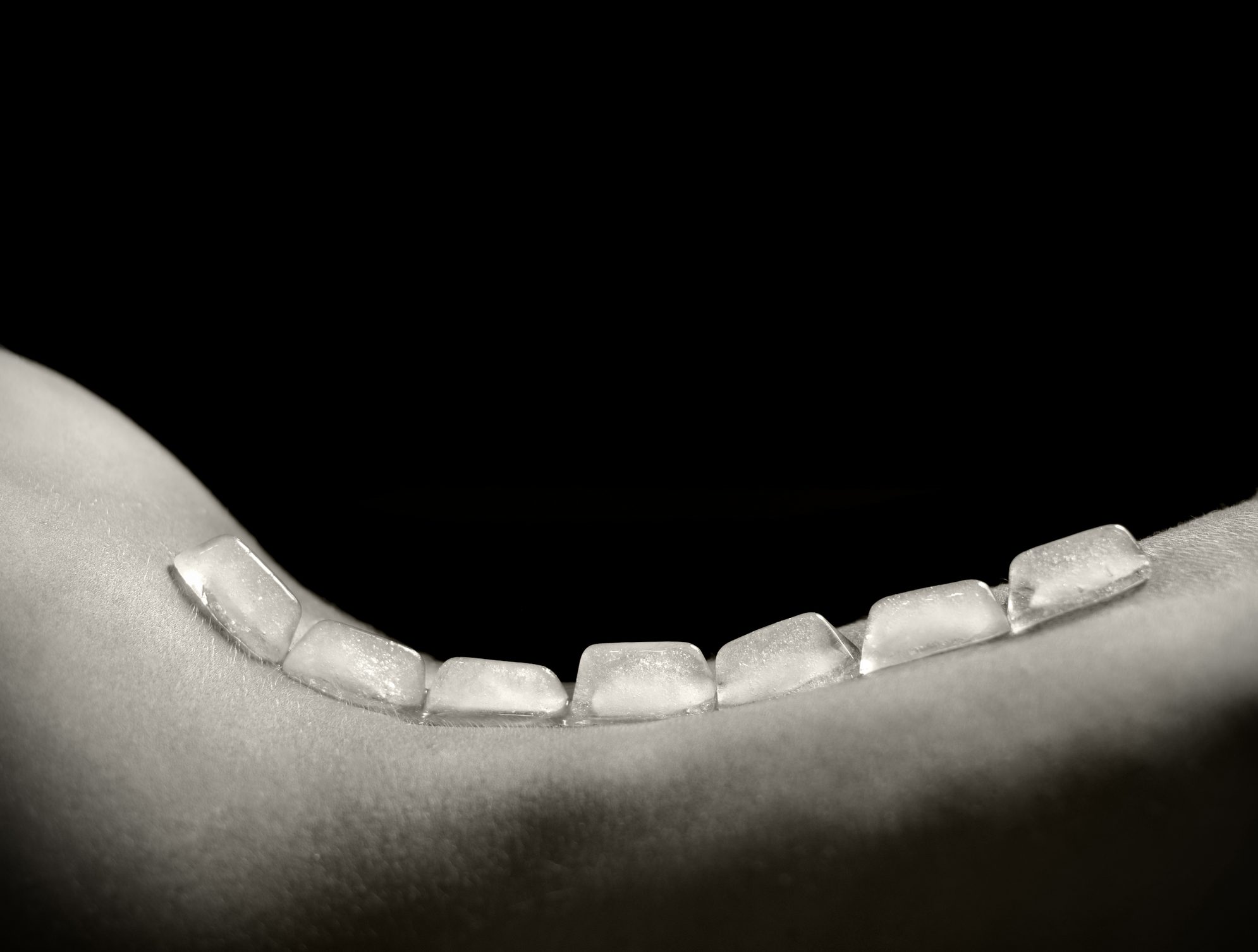 Ice cubes on a back of the girl