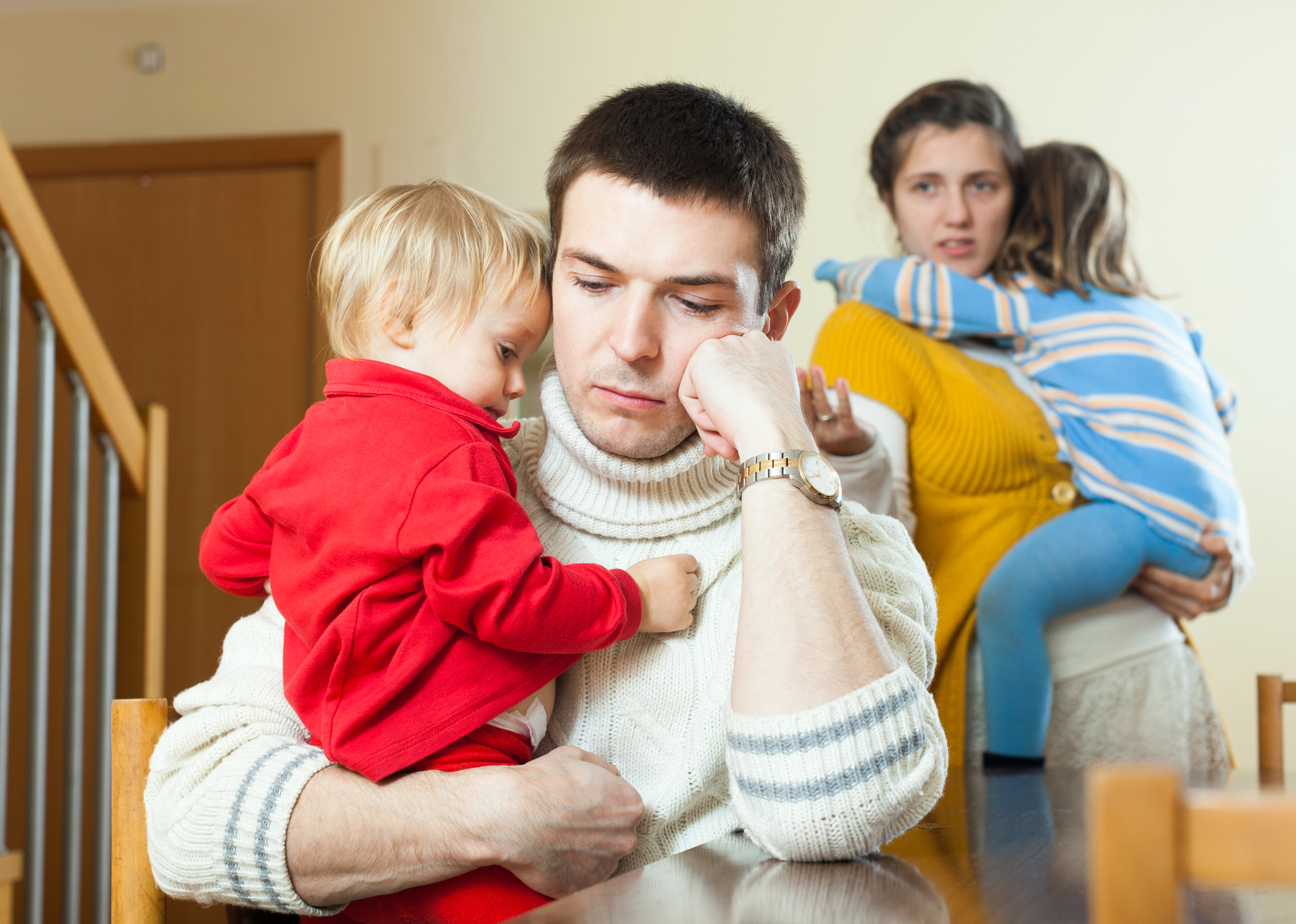 Ordinary young sad family of four after quarrel