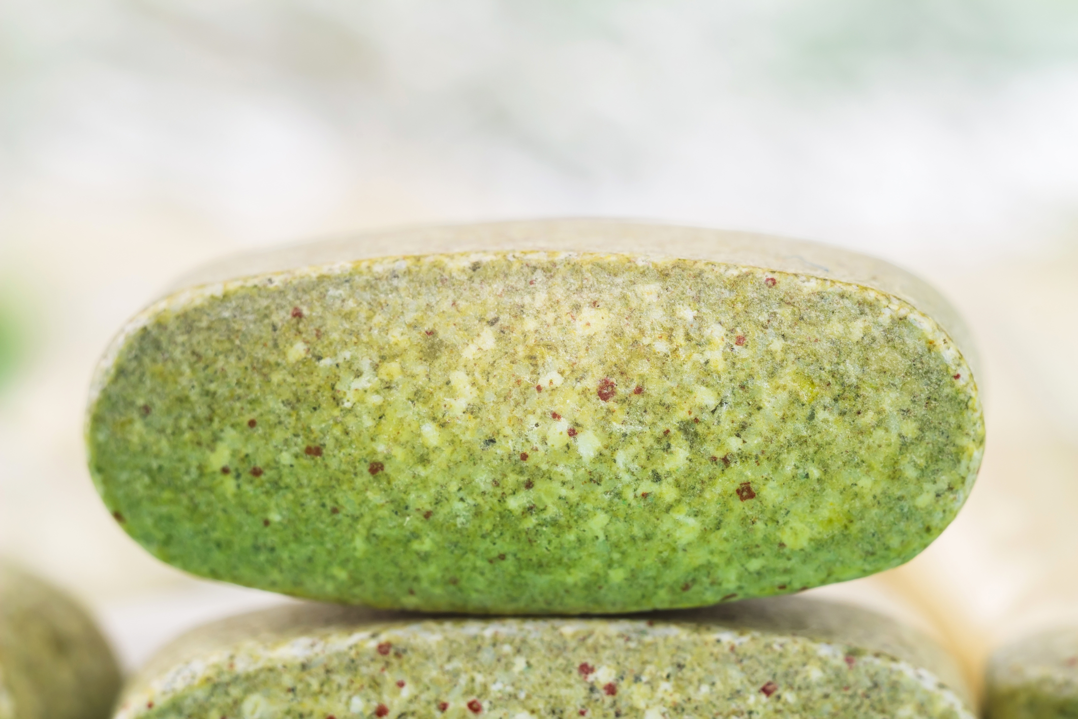 Natural food supplement pills, multivitamin tablet macro image, soft blurred background.