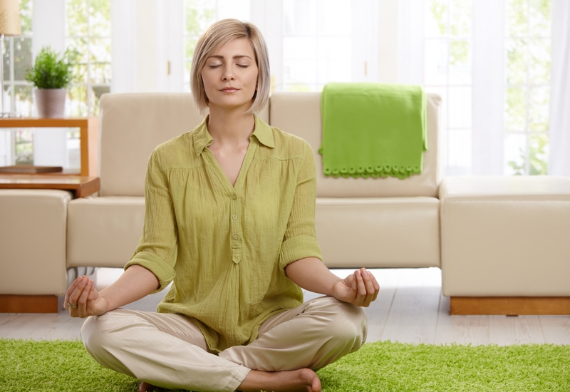 Woman doing yoga meditation at home